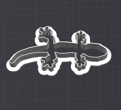Screenshot from a 3D printer slicer showing a gecko-shaped cookie cutter design with defined contours and tail details, ready for printing.