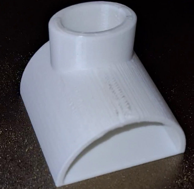 3D-printed 'The Cave' aquarium accessory made with Creality white PLA on a PEI build plate, featuring a cylindrical entrance and smooth, sloping sides for against-the-glass tank placement.
